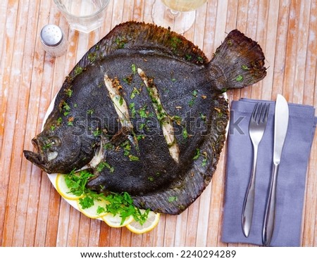 Delicious grilled brill garnished with lemon slices and fresh parsley..