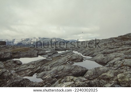 Ponds on rocky mountain slope landscape photo. Beautiful nature scenery photography with cloudy sky on background. Idyllic scene. High quality picture for wallpaper, travel blog, magazine, article
