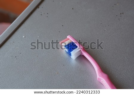 
close up of a pink toothbrush