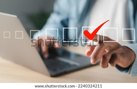 Businessman touching square box with correct icon on virtual interface.