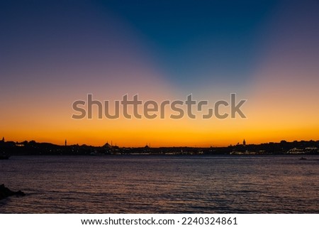 Istanbul skyline with crepuscular rays on the sky. Rare sunset view over the Istanbul.