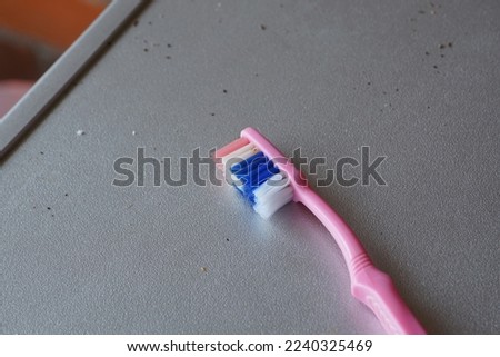 
close up of a pink toothbrush