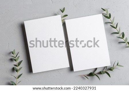 Invitation card mockup with eucalyptus twigs, front and back sides, blank card with copy space