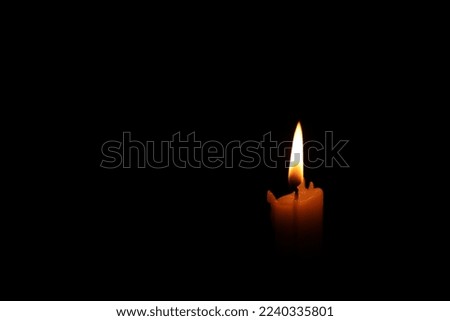 Burning wax candle in darkness. Space for text