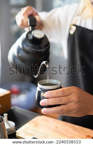 Baristas prepare hot coffee beans in cup pot. to make coffee for steam. Coffee shop concept. in cafe shop for drink,small business