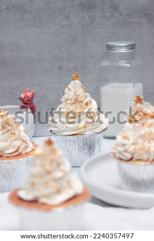 Christmas theme cupcakes with buttercream standing on a white plate