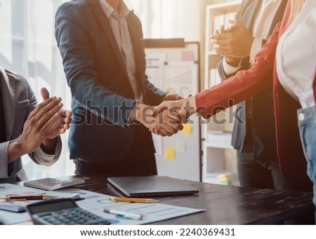 Group business workers handshake at meeting at office meeting room, from joint investment and success in the project after meeting stock market project.