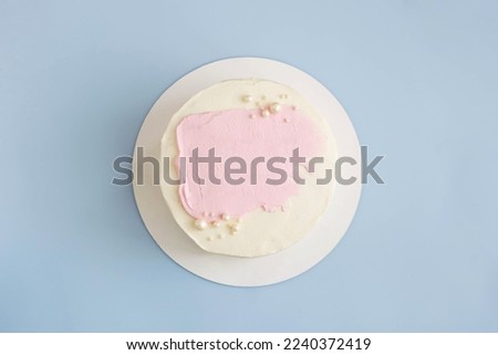 Cake decorated with white cream pink smear. Sweet holiday dessert, valentine's day birthday, wedding