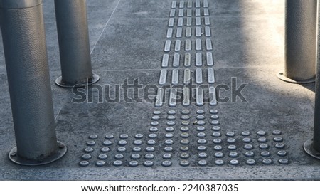 Stainless steel Tactile paving with textured ground surface on the side street. indicators and direction for blind and visually impaired. Blindness aid, visual impairment, independent life concept.