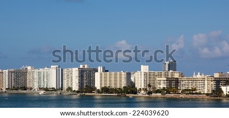 Row of nondescript apartment buildings by the water in Miami, FL, USA.