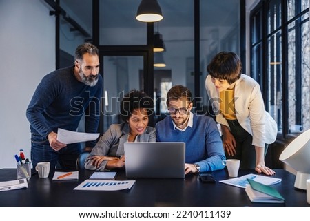 Businesspeople are looking at the laptop at the office and collaborating on start up project. Royalty-Free Stock Photo #2240411439