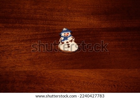 colorful gingerbread cookies on a brown lacquered table top