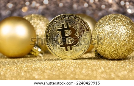 Bitcoin golden coin on a shiny Christmas background stock photo images. Cryptocurrency Bitcoin and christmas glitter balls with bokeh lights stock image. Digital gold and baubles still life images