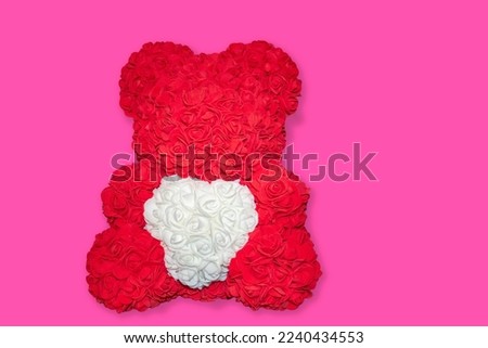 Red Rose Bear With Pink Background. Red Bear from Foamiran Roses. White Heart in Plush Paws. Photo on a Light Background.