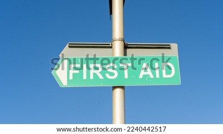 First Aid Sign Attached To Lamppost