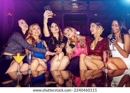 Selfie, club and women with drinks at a party for new year, birthday or festive celebration. Fun, social and friends taking picture on a phone while drinking alcohol beverage in nightclub together.