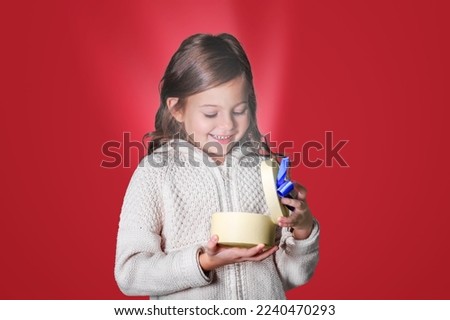 Child hold a beautiful Christmas present gift box