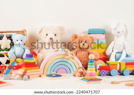 Educational kids toys collection. Teddy bear, wood plane, train, abacus, rainbow, wooden educational baby toys on white background. Sustainable, eco-friendly toys. Front view Royalty-Free Stock Photo #2240471707