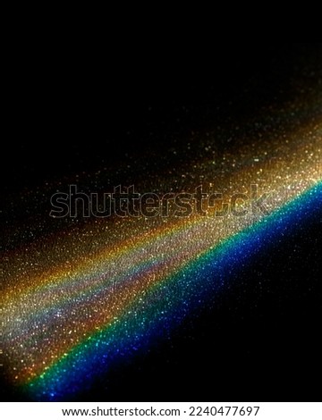 Rainbow sun flares on black background, colorful glare and shine, light rays on sparkling surface. Rainbow refraction of bright sunlight on dark fon. Natural light effects, trend aesthetic photo Royalty-Free Stock Photo #2240477697