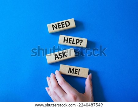 Need help ask me symbol. Concept words Need help ask me on wooden blocks. Beautiful blue background. Businessman hand. Business and Need help ask me concept. Copy space