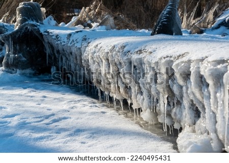 Frozen ice formations at a bathing jetty at the Westensee in Schleswig-Holstein on a sunny winter day