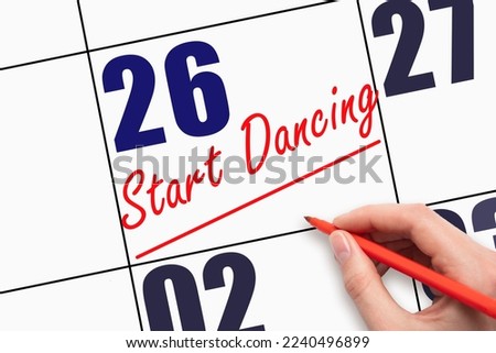 26th day of the month. Hand writing text START DANCING and drawing a line on calendar date. Save the date. Deadline. Business concept Day of the year concept.