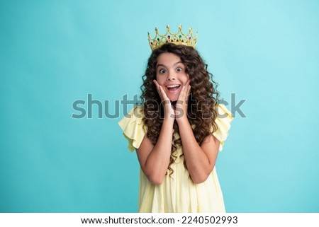 Little queen wearing golden crown. Teenage girl princess holding crown tiara. Prom party, childhood concept. Happy teenager, positive and smiling emotions of teen girl.