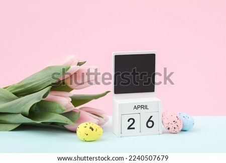 Happy easter. Calendar with date april 26, tulips and easter eggs on pastel background