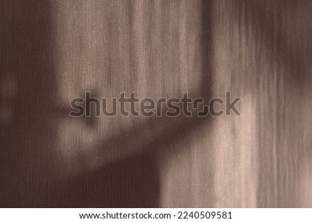 Diagonal and vertical shady stripes cast on light wall macro view. Vintage style decorative element. Psychological state and mood