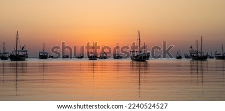Arab traditional dhows in the shore during the sunrise in Qatar Royalty-Free Stock Photo #2240524527