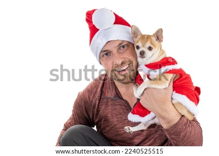 Man and puppy with christmas hat and dress isolated on a white background