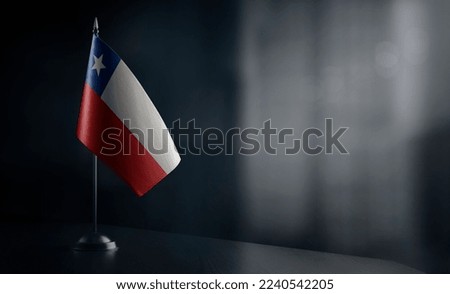 Small national flag of the Chile on a black background.