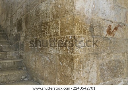 Crusader graffiti engraved in the staircase to the Chapel of Saint Helena. Church of the Holy Sepulchre. Jerusalem, Israel Royalty-Free Stock Photo #2240542701