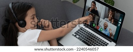 Back view of young girl sit at home, talk have online video call lesson with teacher or tutor, teenage schoolgirl engaged in webcam conversation, study distant use web conference app on laptop