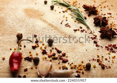 Spices on table with spoon silhouette, close-up 