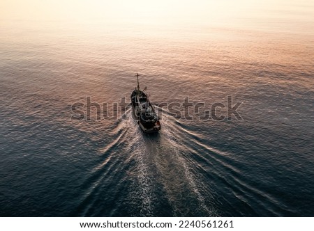 Small Fishing Boat catch fish, aerial Top View from drone. Industrial commercial fishing Royalty-Free Stock Photo #2240561261