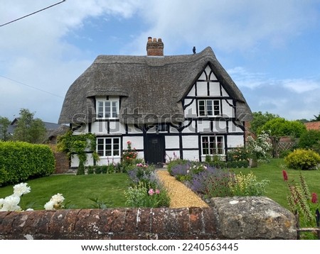 A thatched-roof home in the heart of Somerset, England. Royalty-Free Stock Photo #2240563445