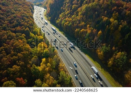 I-40 freeway in North Carolina leading to Asheville through Appalachian mountains in golden fall with fast moving trucks and cars. Interstate transportation concept Royalty-Free Stock Photo #2240568625