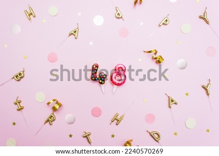 Numerals 48 in the form of sweet donuts are surrounded by festive decor. Forty eight year birthday celebration concept. Selective focus