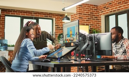 Diverse photo editors retouching pictures with editing software, working on photo color grading. Creative agency artists editing images for multimedia production, doing design teamwork.