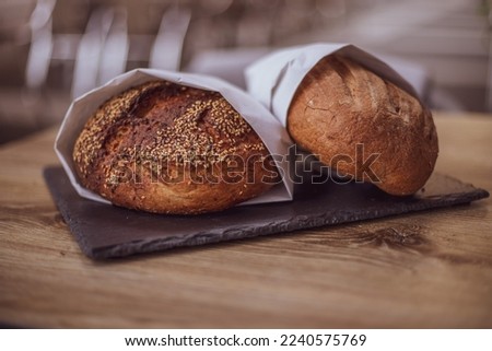 Fresh bread in a paper bag on a wooden table. The concept of natural products. gluten free bread.