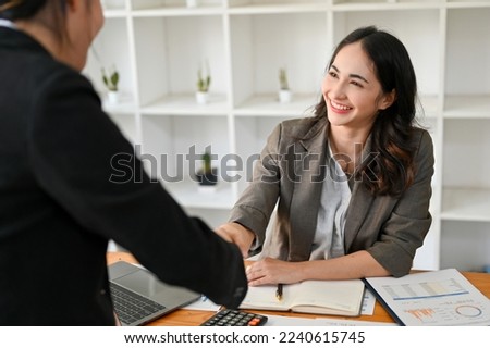 Successful and confident businesswoman shaking hand with her business partner. welcome, congratulations, partnership. Royalty-Free Stock Photo #2240615745