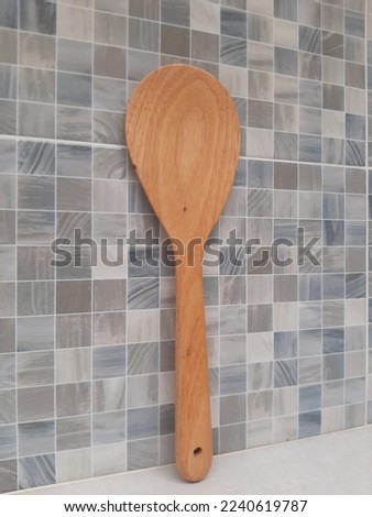 a wooden spoon for cooking picture with ceramic background