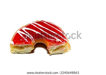 Strawberry flavor ring donut with white chocolate sauce, glazed, yeast raised, American style ring doughnut, type of food made from leavened deep fried dough sweet snack, selective focus and isolated