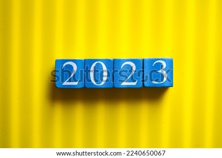 Wooden cactus number 2023 on yellow background,New Year,copy scale for text.