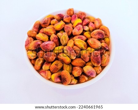 Pistachio nut kernels dry fruit food heap in a bowl pista closeup view image stock photo