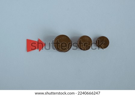 Euro cent coin and arrow on white background.