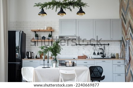 Merry Christmas and Happy New Year. Modern kitchen interior decorated for Christmas