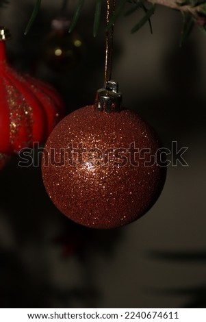 Orange glitter Christmas ball found in a natural tree 