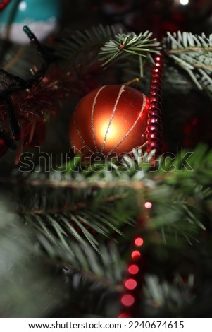 Orange glitter Christmas ball found in a natural tree 